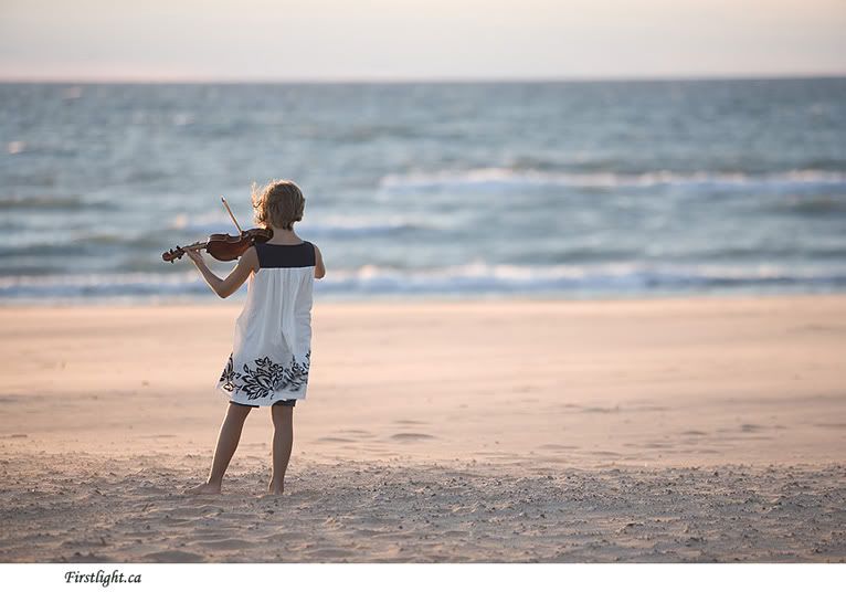 Girl playing violine on the beach Pictures, Images and Photos